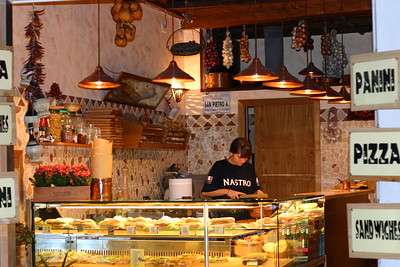 woman making panini in deli