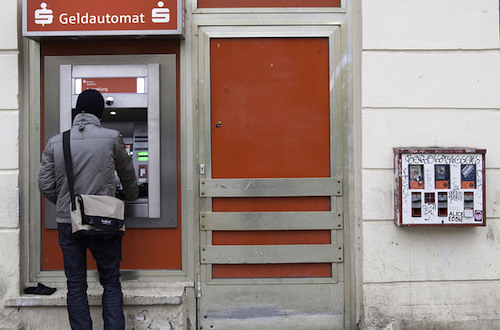 Withdrawing cash from ATM machines like this one in Berlin is almost always cheaper than converting dollars on your own. Photo: skohlmann